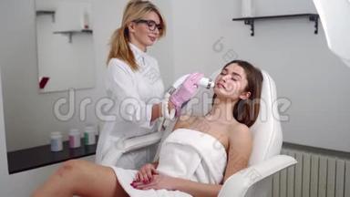 漂亮的金发美容医生，为躺在美容院的女人做射频提升手术。 硬件美容
